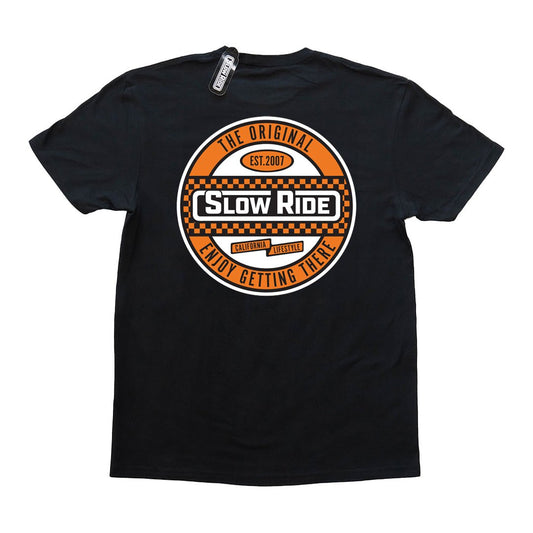 Checkered Tee (4 Colors) - Slow Ride Bold Slow Ride t-shirt featuring an eye-catching circular logo with a checkered design in orange and black, celebrating the vintage Volkswagen lifestyle. This black slow ride shirt is perfect for enthusiasts of the Volkswagen bus, Volkswagen bug, and Baja bug, blending Off-Roading and Off-Road Racing culture with a classic, laid-back vibe. Ideal for those who appreciate the thrill of the journey and the timeless appeal of vintage Volkswagen vehicles.