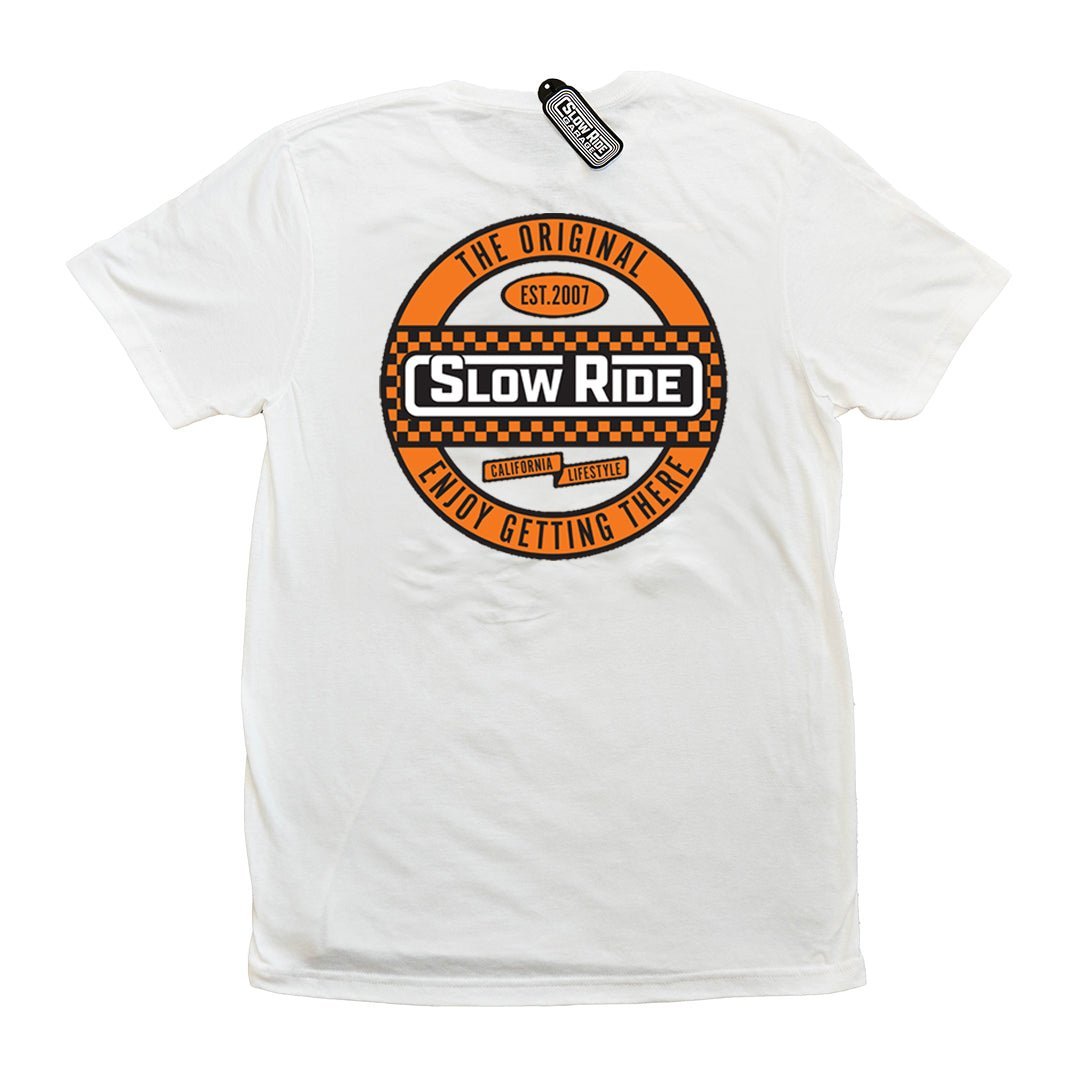 Checkered Tee (White) - Slow Ride Bold Slow Ride t-shirt featuring an eye-catching circular logo with a checkered design in orange and white, celebrating the vintage Volkswagen lifestyle. This white slow ride shirt is perfect for enthusiasts of the Volkswagen bus, Volkswagen bug, and Baja bug, blending Off-Roading and Off-Road Racing culture with a classic, laid-back vibe. Ideal for those who appreciate the thrill of the journey and the timeless appeal of vintage Volkswagen vehicles.