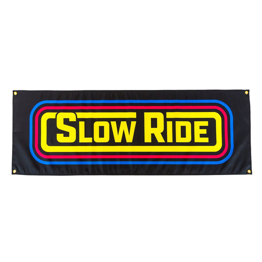 Radio Banner - Slow Ride- Bold Slow Ride banner featuring a vibrant, retro-inspired design with yellow, red, and blue stripes on a black background. Ideal for Off-Roading and Off-Road Racing enthusiasts, this banner celebrates vintage Volkswagen culture, including the iconic Volkswagen bus, Volkswagen bug, and Baja bug. Perfect for decorating your Garage and Racing space, Slow Ride Garage, or any blue-collar workwear environment. Display your passion for the slow ride lifestyle with mottos like 'Enjoy Getti