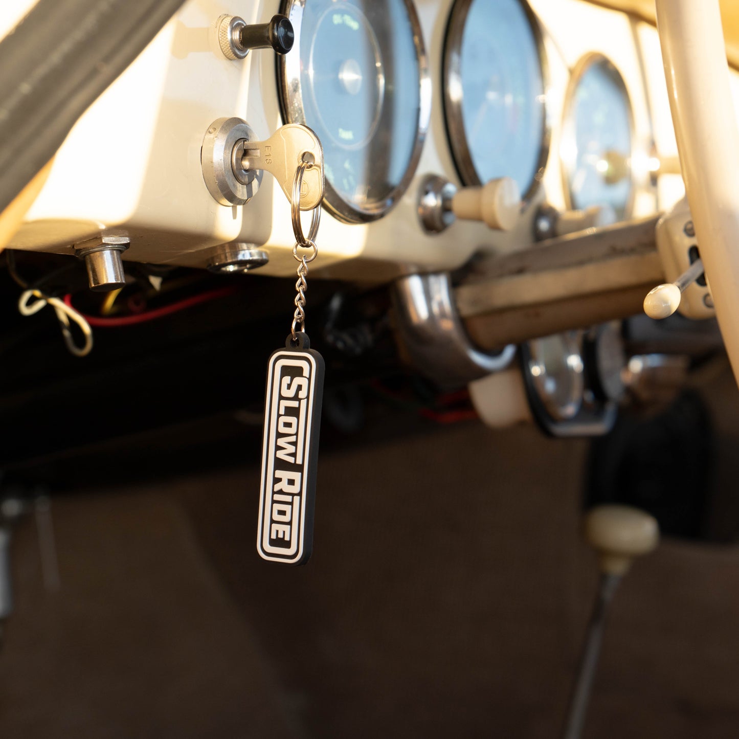 Radio Keychain - Slow Ride- Classic Slow Ride keychain featuring the iconic 'Slow Ride' logo in black and white, perfect for fans of Off-Roading and Off-Road Racing. This keychain is an ideal accessory for vintage Volkswagen enthusiasts, including those who love the Volkswagen bus, Volkswagen bug, and Baja bug. A great addition to any Garage and Racing lifestyle, this keychain embodies the spirit of Slow Ride Garage and mottos like 'Enjoy Getting There,' 'Wheelin and Spilling,' and 'Restore and Destroy.' A 