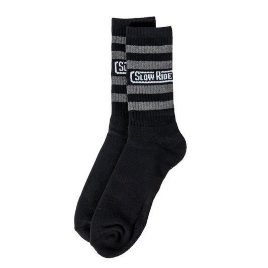 Radio Sock Black/Charcoal - Slow Ride- Set of Slow Ride socks featuring bold stripes in red, blue, and gray, perfect for fans of Off-Roading, Off-Road Racing, and vintage Volkswagen culture. These socks are an ideal accessory for enthusiasts of the Volkswagen bus, Volkswagen bug, and Baja bug, embodying the Garage and Racing lifestyle. Designed in California, these socks are a great addition to your blue-collar workwear collection, perfect for those who live by mottos like 'Enjoy Getting There,' 'Wheelin an