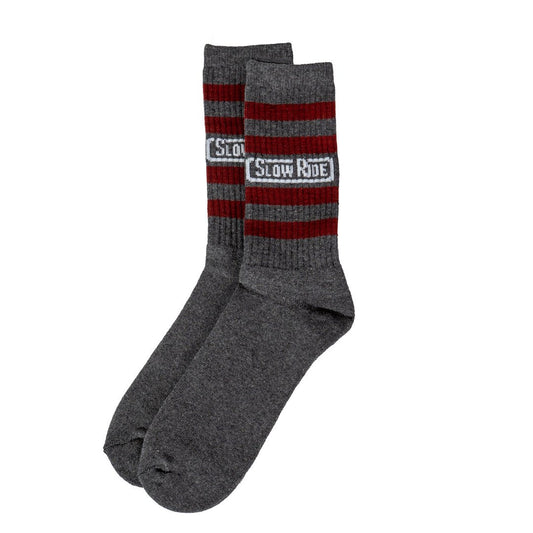 Radio Sock Burgundy/Charcoal - Slow Ride- Set of Slow Ride socks featuring bold stripes in red, blue, and gray, perfect for fans of Off-Roading, Off-Road Racing, and vintage Volkswagen culture. These socks are an ideal accessory for enthusiasts of the Volkswagen bus, Volkswagen bug, and Baja bug, embodying the Garage and Racing lifestyle. Designed in California, these socks are a great addition to your blue-collar workwear collection, perfect for those who live by mottos like 'Enjoy Getting There,' 'Wheelin