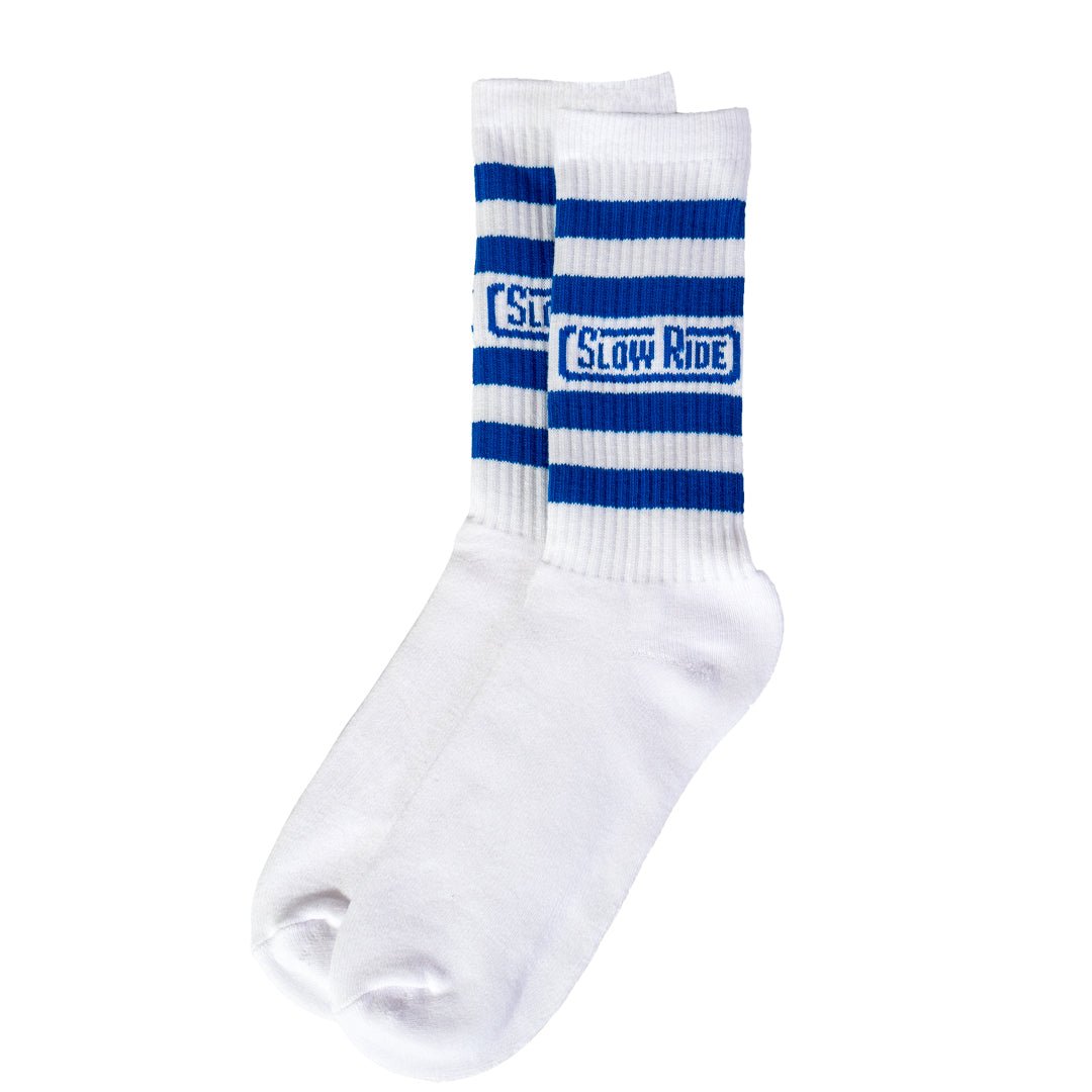 Radio Sock White/Blue - Slow Ride- Set of Slow Ride socks featuring bold stripes in red, blue, and gray, perfect for fans of Off-Roading, Off-Road Racing, and vintage Volkswagen culture. These socks are an ideal accessory for enthusiasts of the Volkswagen bus, Volkswagen bug, and Baja bug, embodying the Garage and Racing lifestyle. Designed in California, these socks are a great addition to your blue-collar workwear collection, perfect for those who live by mottos like 'Enjoy Getting There,' 'Wheelin and Sp